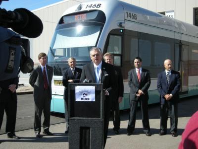 photo of Secretary LaHood giving talk in front of light rail car