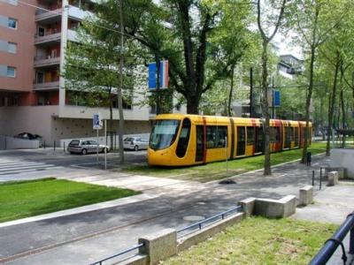 photo of tram on green rail bed, St. Etienne